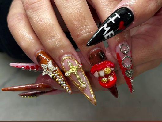 Trending for nail art with brown black and red design, 3-D lips with teeth charm stars crosses piercings pearls hand written I love me