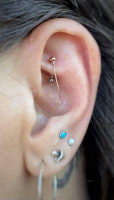 Look at this fun jewelry upgrade for this rook piercing. Featuring a rose gold, "Kite Tail" by Quetzalli.