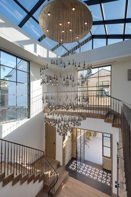 Balboa Entry- custom chandelier resembling water droplets , 200 year old oak, custom metal railing, tiled entry