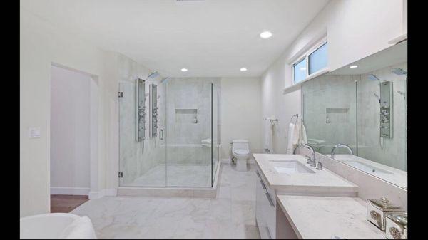 Frameless shower enclosure