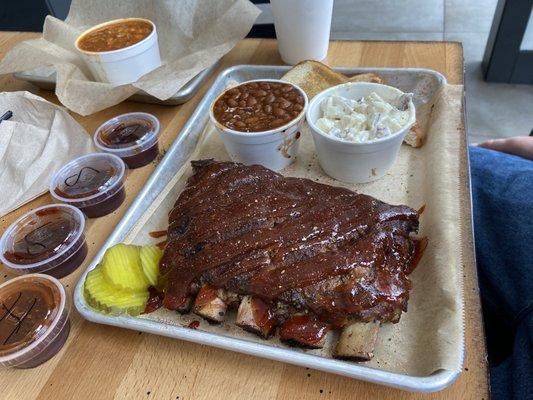 Rib plate with potato salad, baked beans, Brunswick stew and some of the hot and sweet sauces