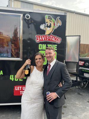 My husband and I on our wedding day with Javi's food truck