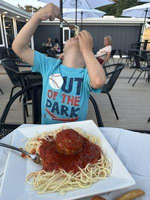 Kid enjoying the kids pasta & meatball