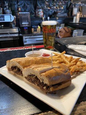 French Dip Sandwich with au jus, fries and a cold beer. Damn sandwich crackles and pops when you bite into it, it talks to you.