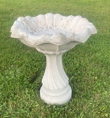 Two piece "tulip" bird bath. Solid concrete top and bottom. Discoloration in top is from rain. Blue jays and robins love bathing in it.