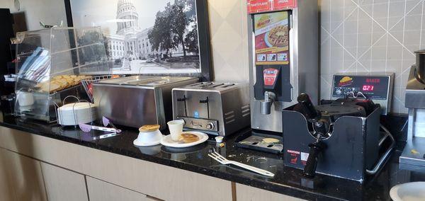 Filthy counter 
 8 a.m. 
 Multiple items out
 Desk person talking on phone in room behind counter