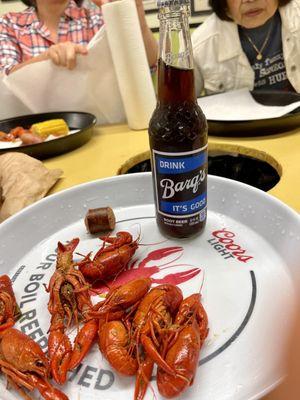 Crawfish with sausage and glass bottle Barq's. Corn in the back-round.