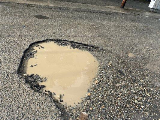 huge pot hole in parking lot