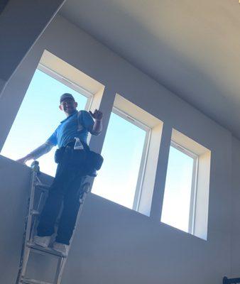 Mike cleaning the inside of our two story dining room windows!