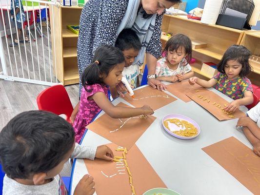 Children are engaged in making an imitated dinosaur fossil making.