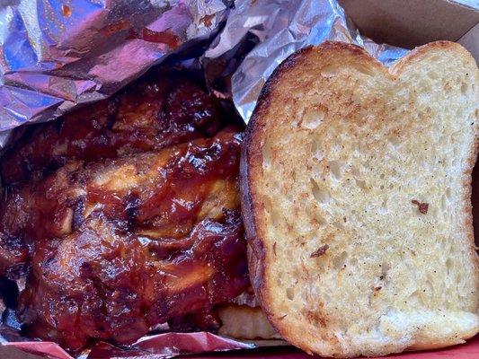 Rib special with fries and garlic bread.