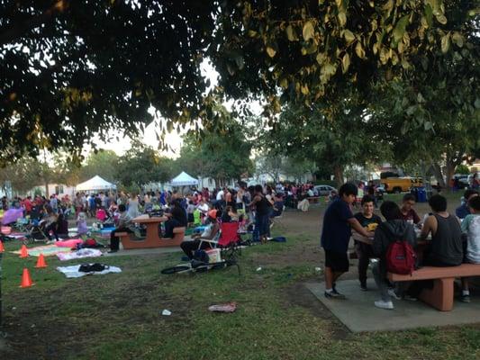 Signs said Movie at the Park at Reynier Park.  A lot of people were lining up for apparently free hot dogs provided by the city