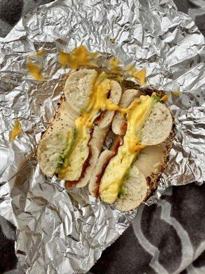 Egg bacon cheese avocado on everything bagel