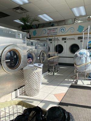 Medium washer $5.25 Large dryers in back Multiple carts and 2 folding stations