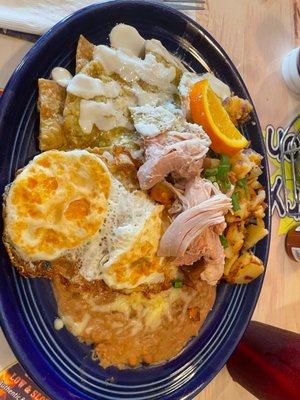 Green chilaquiles with chicken. The chicken doesn't look that great in the photo lol but it was okay! Could have gone without it tbh!