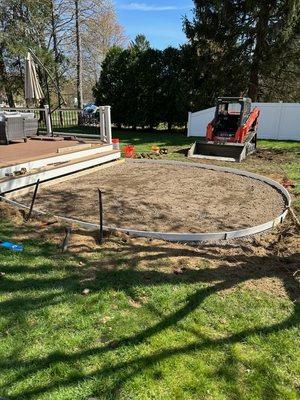 Prep for concrete patio with fire pit.