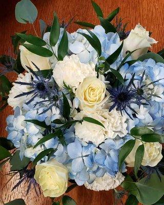 Beautiful blend of blues and white, including hydrangeas, roses, thistle and more