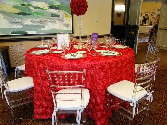 Red Rosette table cloth with Clear Chiavari chairs