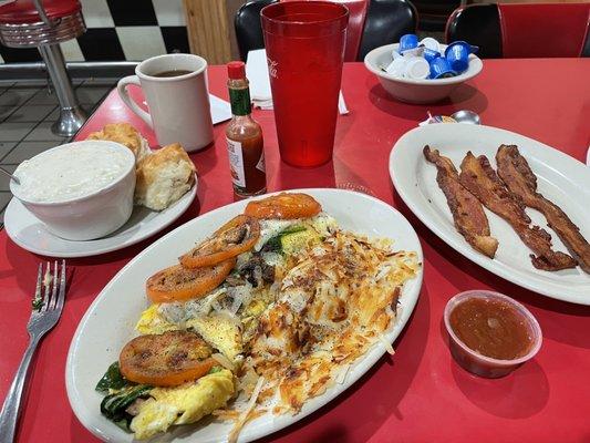 Garden omelette substituted with real eggs, hash browns, bacon, and biscuits with gravy