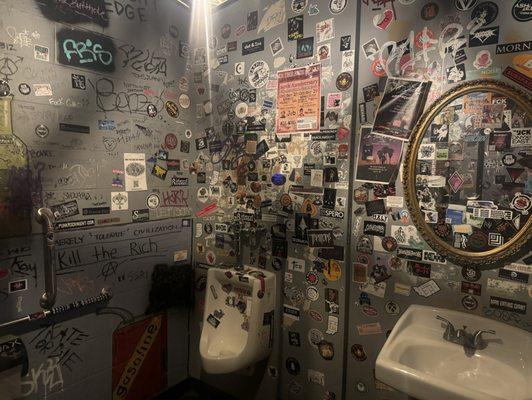 Unisex bathrooms covered in stickers