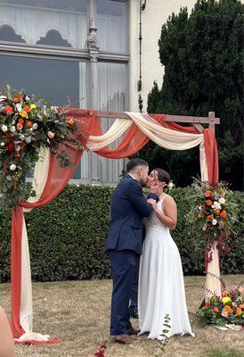 Wedding Arch draping and flowers from Magda's Flowers.