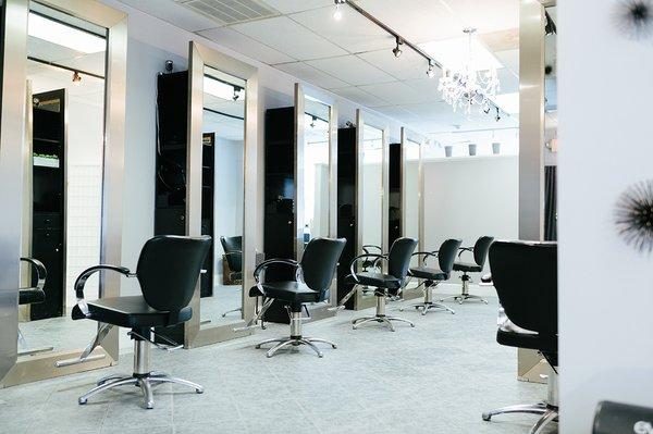 Inside our salon. Chairs are currently spaced out between dividers.