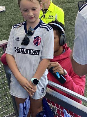 Team member autographing a kids shirt