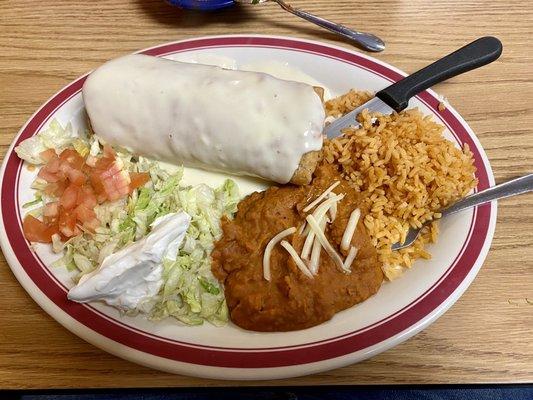 This is a chicken chimichanga with rice and beans.