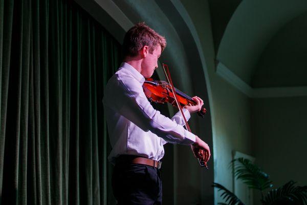 Student playing violin at our strings recital.