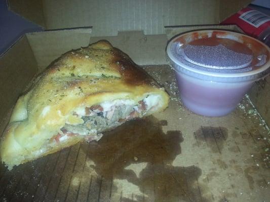 1/2 of a Meat pie California with marinara sauce in the cup.  It's Huge and yummy.