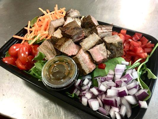 Lean Flank Steak over organic greens salad