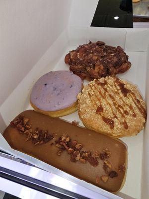 Maple bar with bacon, Carmel apple , blueberry with lemon filling and an apple fritter