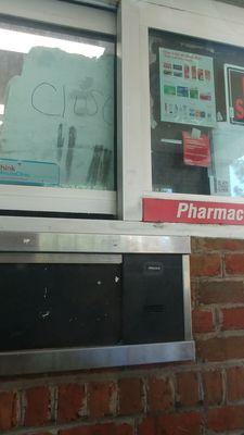 Pharmacy drive thru is closed. Cardboard sign.