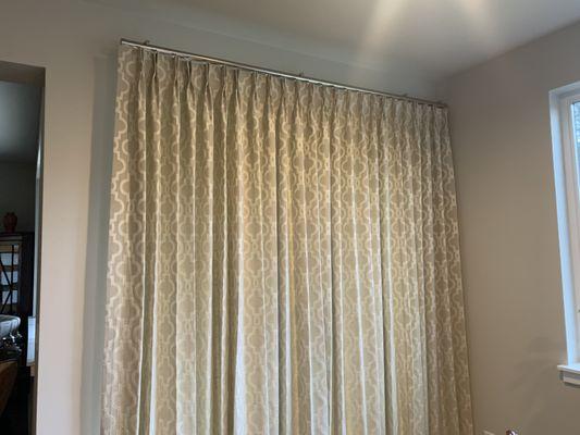 Two finger pinch pleat draw drapery on Kirsch designer metal hardware for sliding glass door.