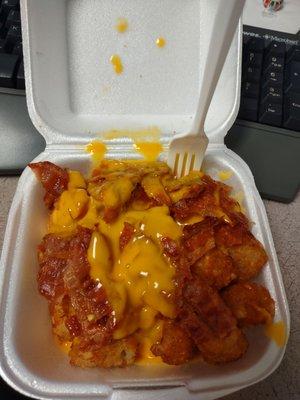 Tater tots w/ bacon & nacho cheese. Don't know the price, I bought a few things along with them. They're probably $5-$6. Hella good!