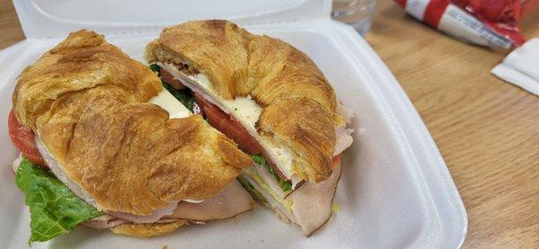 Turkey, avocado, cheese, lettuce, tomato, and mayo on a croissant. Yum!