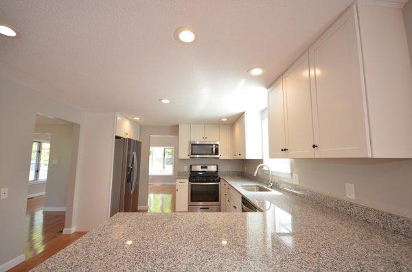 New kitchen with hardwood flooring.