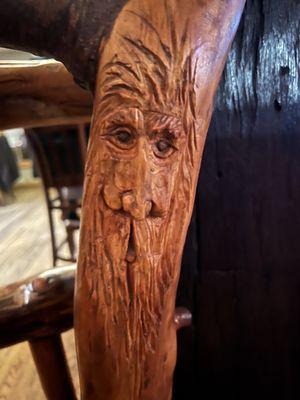 Carving in the railing that you would never notice next to the bar.