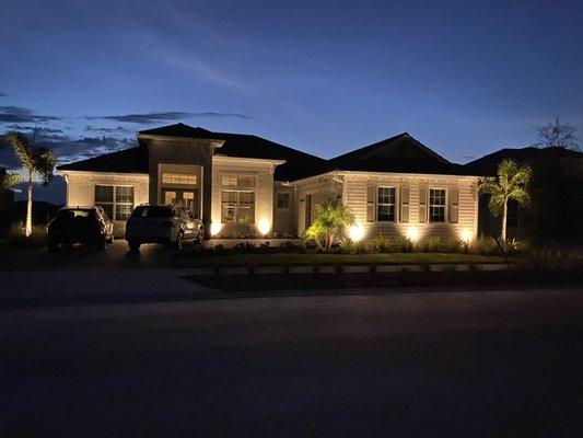 The outside of the home with all the beautiful landscape lighting