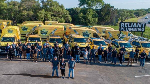 Team photo with fleet of vehicles