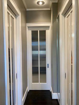 Our master bathroom pocket door with tempered reeded glass panels.