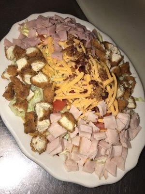 LG. chicken chef salad made with fresh lettuce, diced tomatoes, ham, turkey, bacon, & shredded cheese. We have homemade dressings as well!