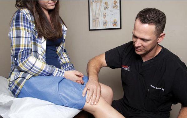 Dr. Greene examining a patient's knee