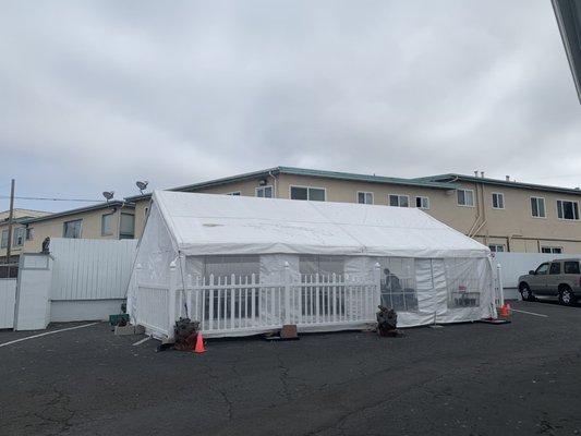 Covered outdoor dining tent open from 1 side