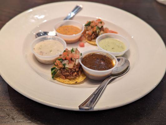 Soup sampler with oyster nachos. Soups include roasted jalapeno, clam chowder, crab bisque, and gumbo.