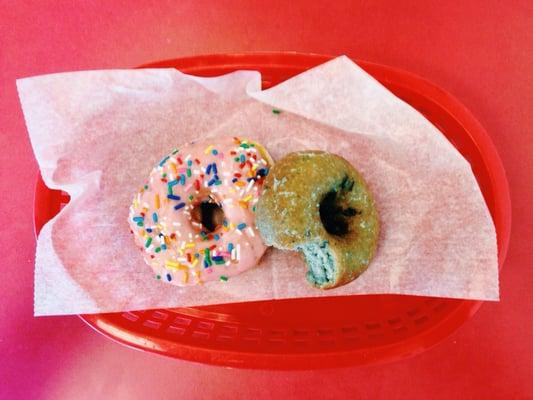 Blueberry cake donut and an iced donut. I took a bite of my donut because I couldn't wait.