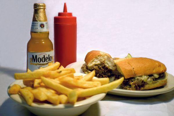 Our delicious cheesesteak sub with fries and a Modelo.