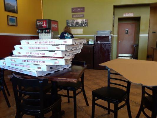 Pizza boxes on two tables in dinning room