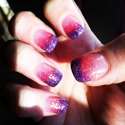 Gel nails with colored powder. Purple to pink ombré