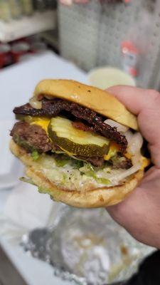 Single cheeseburger with bacon, pickles, grilled onions, tomato and mayo - Absolutely delicious!